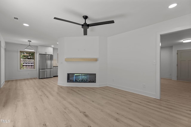 620 Red Carriage Ave, Durham, NC 27704 - unfurnished living room featuring ceiling fan, recessed lighting, light wood-style flooring, and a multi sided fireplace