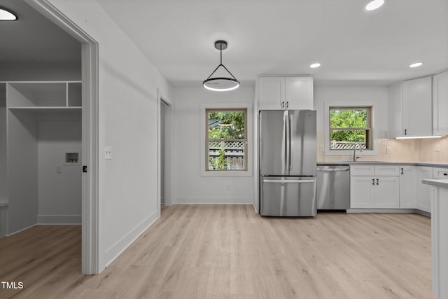 620 Red Carriage Ave, Durham, NC 27704 - kitchen with stainless steel appliances, light wood-type flooring, white cabinetry, light countertops, and recessed lighting