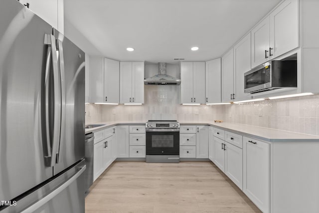 620 Red Carriage Ave, Durham, NC 27704 - kitchen with appliances with stainless steel finishes, wall chimney range hood, light countertops, white cabinetry, and recessed lighting