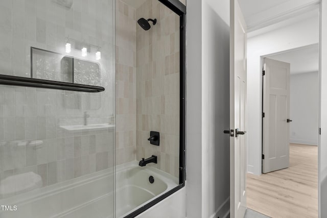 620 Red Carriage Ave, Durham, NC 27704 - bathroom featuring bath / shower combo with glass door and wood finished floors