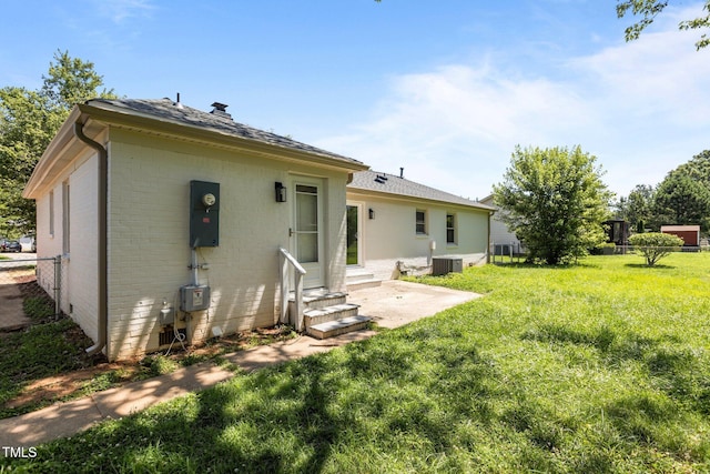 620 Red Carriage Ave, Durham, NC 27704 - rear view of property with entry steps, brick siding, a patio, and a shingled roof