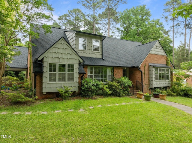 3516 Swift Dr, Raleigh, NC 27606 - view of front of home featuring a shingled roof, a front yard, and brick siding