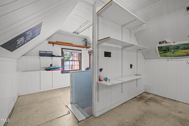 3516 Swift Dr, Raleigh, NC 27606 - kitchen featuring tile patterned floors, vaulted ceiling, and wooden walls