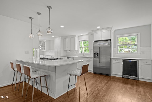 3516 Swift Dr, Raleigh, NC 27606 - kitchen with stainless steel appliances, beverage cooler, tasteful backsplash, white cabinets, and recessed lighting