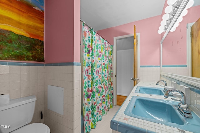3516 Swift Dr, Raleigh, NC 27606 - bathroom featuring tile walls, a wainscoted wall, curtained shower, and double vanity