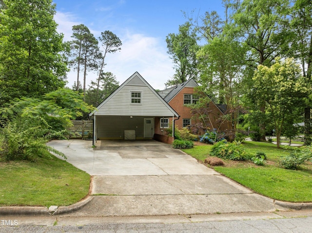3516 Swift Dr, Raleigh, NC 27606 - view of front of home featuring driveway, a front lawn, brick siding, and a carport