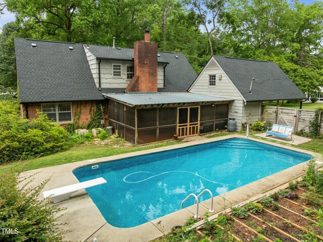 3516 Swift Dr, Raleigh, NC 27606 - swimming pool featuring a sunroom, a diving board, and view of scattered trees