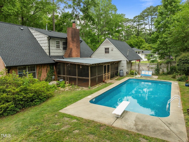 3516 Swift Dr, Raleigh, NC 27606 - swimming pool with a sunroom, a patio area, a diving board, and view of wooded area