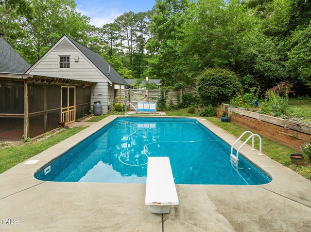 3516 Swift Dr, Raleigh, NC 27606 - view of swimming pool with a diving board, a fenced backyard, view of scattered trees, and a patio