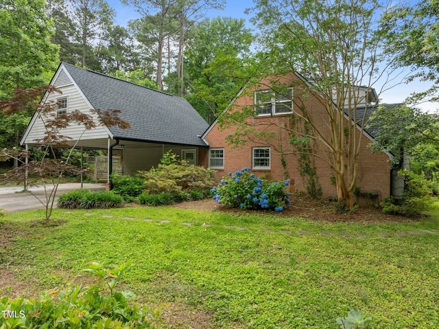 3516 Swift Dr, Raleigh, NC 27606 - view of front of home featuring a front lawn, roof with shingles, brick siding, and driveway