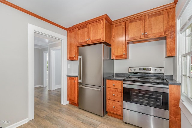 603 S Third St, Mebane, NC 27302 - kitchen featuring stainless steel appliances, dark countertops, ornamental molding, light wood-type flooring, and brown cabinetry