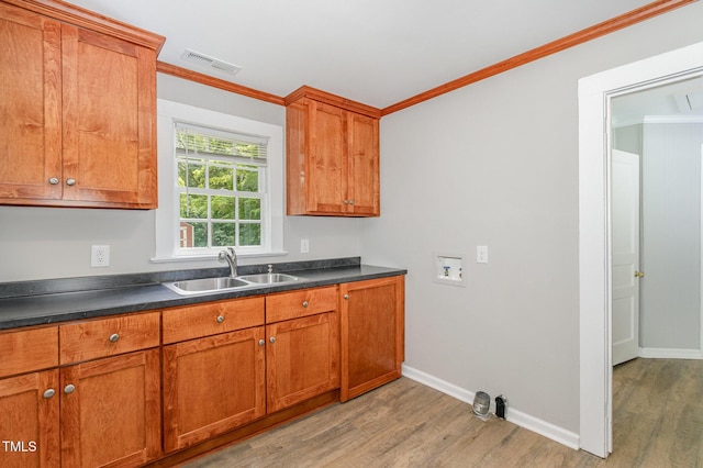 603 S Third St, Mebane, NC 27302 - kitchen featuring light wood finished floors, brown cabinets, ornamental molding, and dark countertops