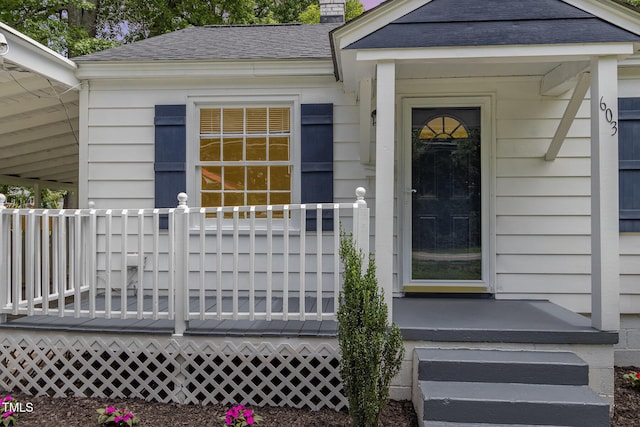 603 S Third St, Mebane, NC 27302 - view of exterior entry with a chimney and a shingled roof