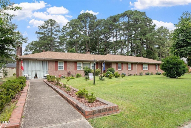 1103 Treemont Rd NW, Wilson, NC 27896 - ranch-style home featuring a chimney, brick siding, and a front lawn