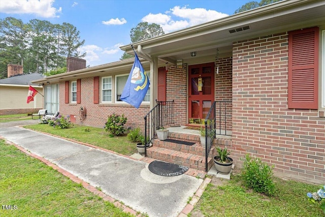 1103 Treemont Rd NW, Wilson, NC 27896 - view of exterior entry featuring a chimney and brick siding