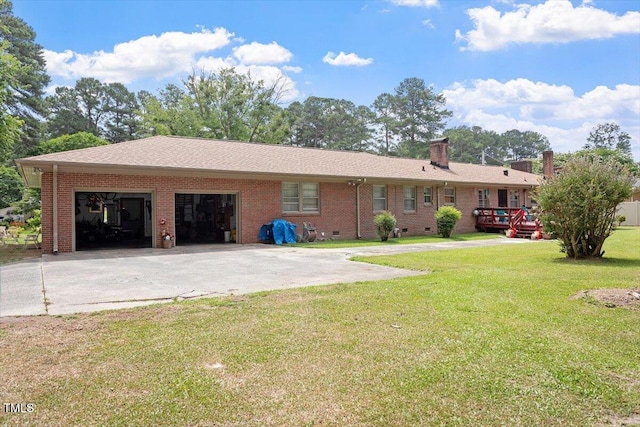 1103 Treemont Rd NW, Wilson, NC 27896 - view of front facade with concrete driveway, brick siding, a garage, a chimney, and a front yard