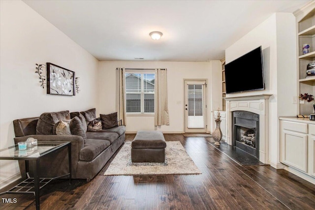 51 Balboa Pkwy, Clayton, NC 27520 - living room featuring dark wood-style flooring and a fireplace with flush hearth