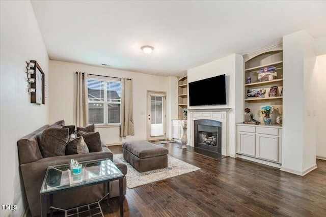 51 Balboa Pkwy, Clayton, NC 27520 - living room featuring a fireplace with flush hearth, dark wood-style flooring, and built in shelves