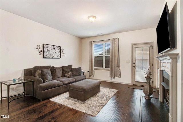 51 Balboa Pkwy, Clayton, NC 27520 - living room featuring dark wood-type flooring and a fireplace with raised hearth