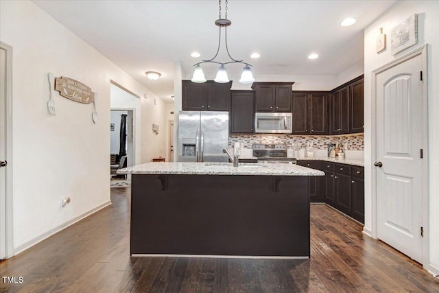 51 Balboa Pkwy, Clayton, NC 27520 - kitchen with appliances with stainless steel finishes, dark brown cabinetry, decorative backsplash, light stone countertops, and dark wood-style floors