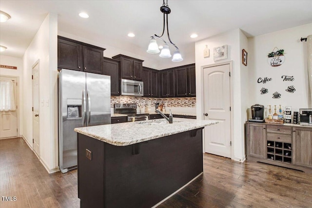 51 Balboa Pkwy, Clayton, NC 27520 - kitchen with appliances with stainless steel finishes, backsplash, dark wood-type flooring, dark brown cabinets, and recessed lighting