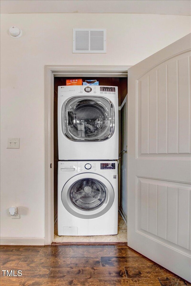 51 Balboa Pkwy, Clayton, NC 27520 - washroom with stacked washer / dryer and wood finished floors
