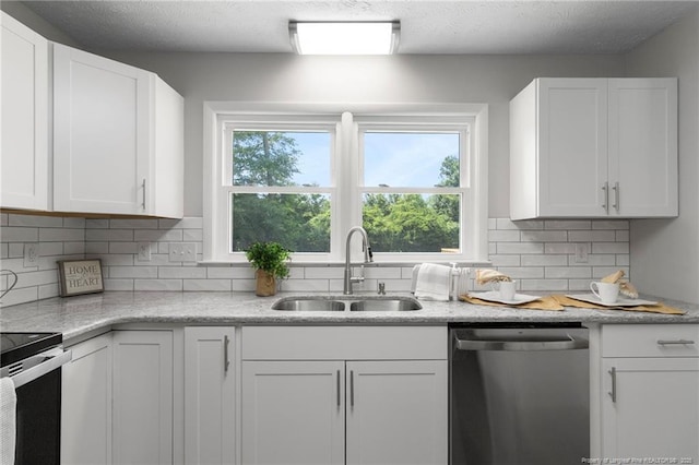 329 W Railroad St, Parkton, NC 28371 - kitchen featuring appliances with stainless steel finishes, white cabinetry, and decorative backsplash