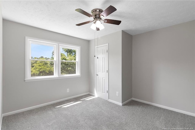 329 W Railroad St, Parkton, NC 28371 - unfurnished bedroom with a textured ceiling, carpet flooring, and ceiling fan