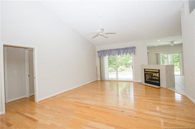 38 Windsong Pl, Whispering Pines, NC 28327 - unfurnished living room featuring a ceiling fan, wood finished floors, high vaulted ceiling, and a tiled fireplace