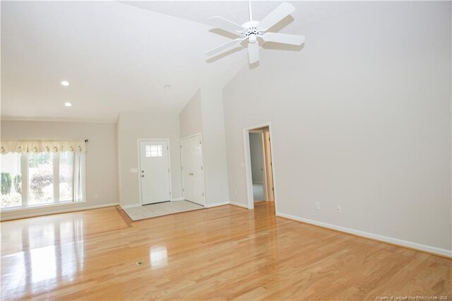 38 Windsong Pl, Whispering Pines, NC 28327 - unfurnished living room with wood finished floors, high vaulted ceiling, ceiling fan, and recessed lighting