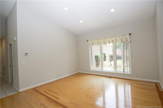38 Windsong Pl, Whispering Pines, NC 28327 - spare room featuring light wood finished floors, recessed lighting, and vaulted ceiling