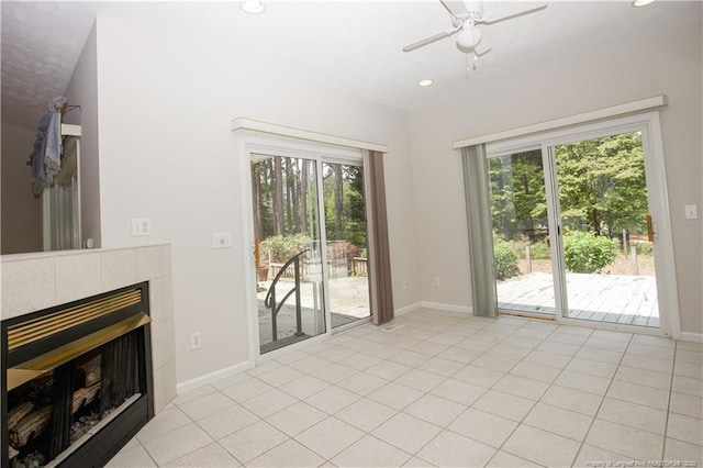 38 Windsong Pl, Whispering Pines, NC 28327 - unfurnished living room with recessed lighting, light tile patterned floors, a tiled fireplace, and ceiling fan