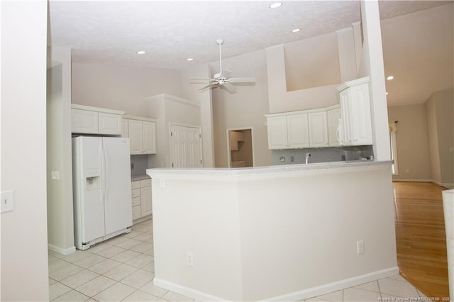 38 Windsong Pl, Whispering Pines, NC 28327 - kitchen featuring white fridge with ice dispenser, a ceiling fan, recessed lighting, white cabinets, and light tile patterned flooring