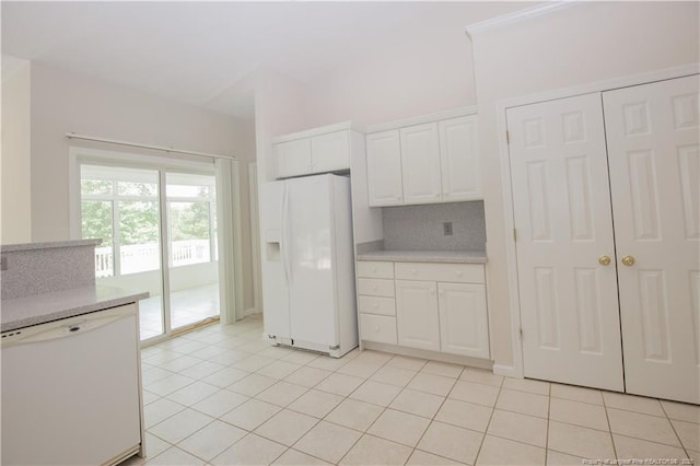 38 Windsong Pl, Whispering Pines, NC 28327 - kitchen with white appliances, light countertops, decorative backsplash, white cabinetry, and light tile patterned floors
