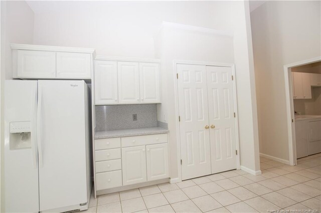 38 Windsong Pl, Whispering Pines, NC 28327 - kitchen featuring white fridge with ice dispenser, light countertops, white cabinetry, tasteful backsplash, and light tile patterned floors