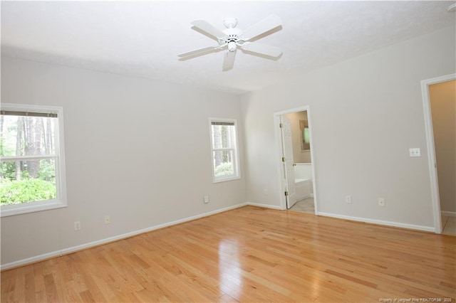 38 Windsong Pl, Whispering Pines, NC 28327 - unfurnished bedroom with multiple windows, light wood-style flooring, and ensuite bathroom