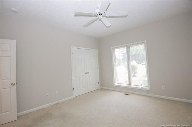 38 Windsong Pl, Whispering Pines, NC 28327 - unfurnished bedroom featuring light carpet, a closet, and ceiling fan