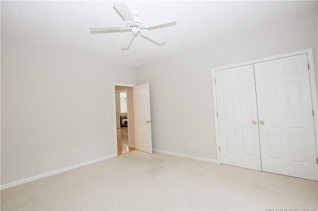 38 Windsong Pl, Whispering Pines, NC 28327 - unfurnished bedroom featuring light carpet, a closet, and a ceiling fan