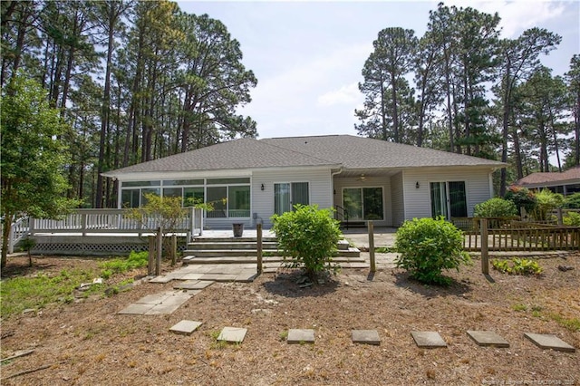 38 Windsong Pl, Whispering Pines, NC 28327 - rear view of property with a wooden deck and a shingled roof