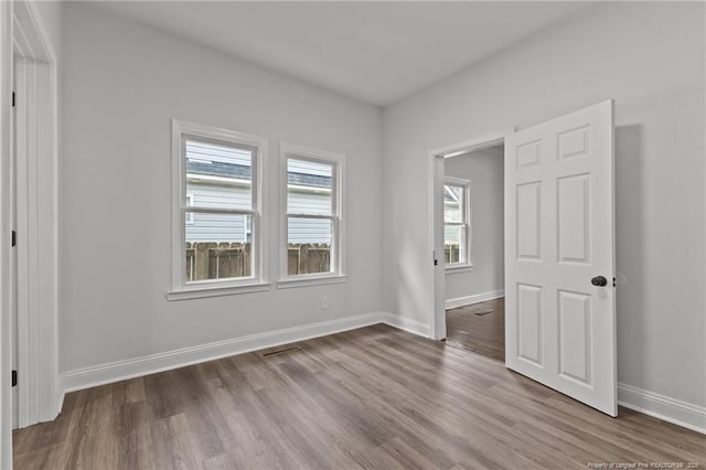 123 John St, Fayetteville, NC 28305 - unfurnished bedroom with wood finished floors