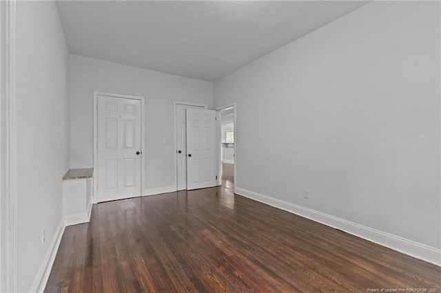 123 John St, Fayetteville, NC 28305 - unfurnished bedroom with dark wood-style floors and baseboards