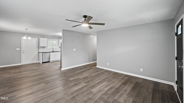 427 Elm Ct, Burlington, NC 27217 - unfurnished living room with a ceiling fan, dark wood-style flooring, a textured ceiling, and a chandelier