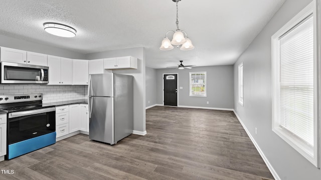 427 Elm Ct, Burlington, NC 27217 - kitchen with stainless steel appliances, a chandelier, white cabinets, decorative backsplash, and a textured ceiling