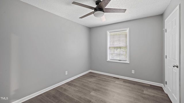 427 Elm Ct, Burlington, NC 27217 - unfurnished bedroom featuring a textured ceiling, dark wood-style flooring, and ceiling fan