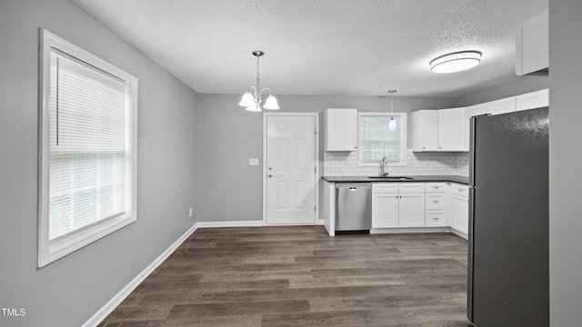 427 Elm Ct, Burlington, NC 27217 - kitchen featuring stainless steel appliances, a textured ceiling, white cabinetry, dark wood finished floors, and tasteful backsplash