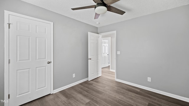 427 Elm Ct, Burlington, NC 27217 - unfurnished bedroom with dark wood finished floors, a textured ceiling, and ceiling fan