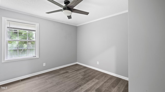 427 Elm Ct, Burlington, NC 27217 - unfurnished room featuring crown molding, ceiling fan, and dark wood-style floors