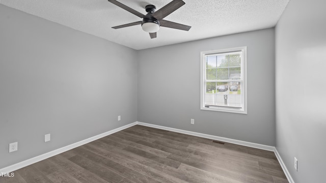 427 Elm Ct, Burlington, NC 27217 - unfurnished room featuring a ceiling fan, dark wood finished floors, and a textured ceiling