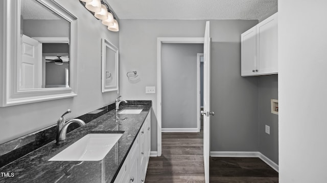 427 Elm Ct, Burlington, NC 27217 - bathroom featuring double vanity, wood finished floors, a textured ceiling, and a ceiling fan