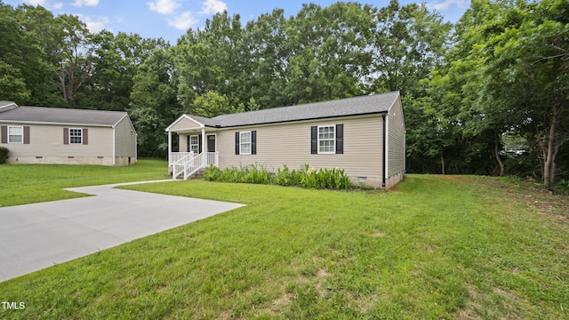 427 Elm Ct, Burlington, NC 27217 - manufactured / mobile home with crawl space, a front lawn, covered porch, and view of scattered trees
